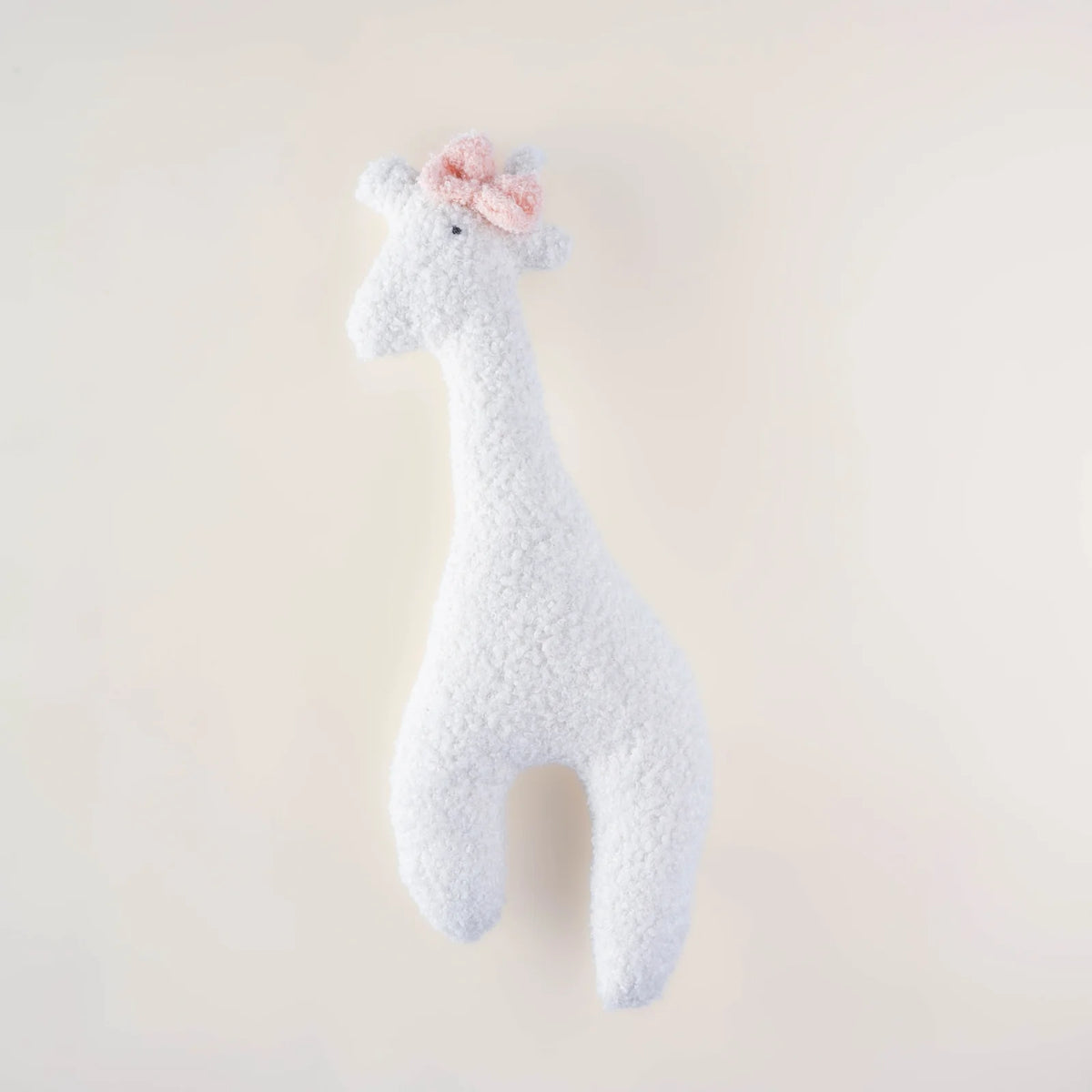Lola the Giraffe white bouclé giraffe cushion with soft pink bow by MYLU