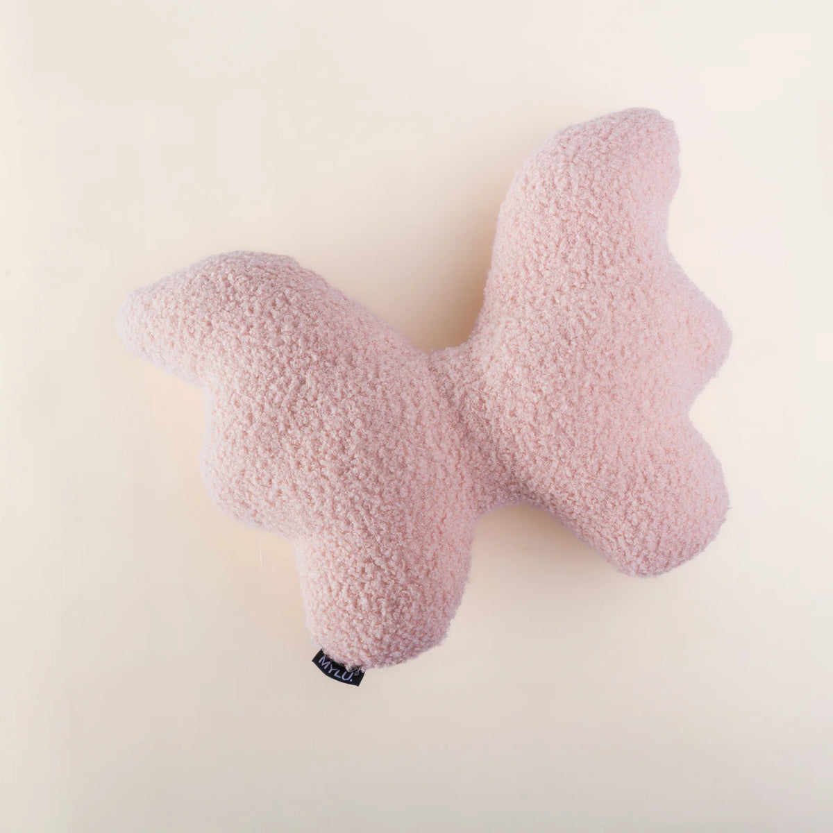 Handmade blush pink bouclé butterfly-shaped cushion by MYLU, Bundle Company