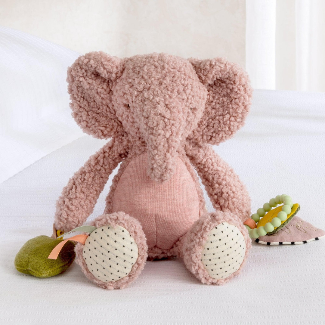 Pink Edie Elephant Activity Toy with textured sensory features and soft curled fur for baby cuddles and play